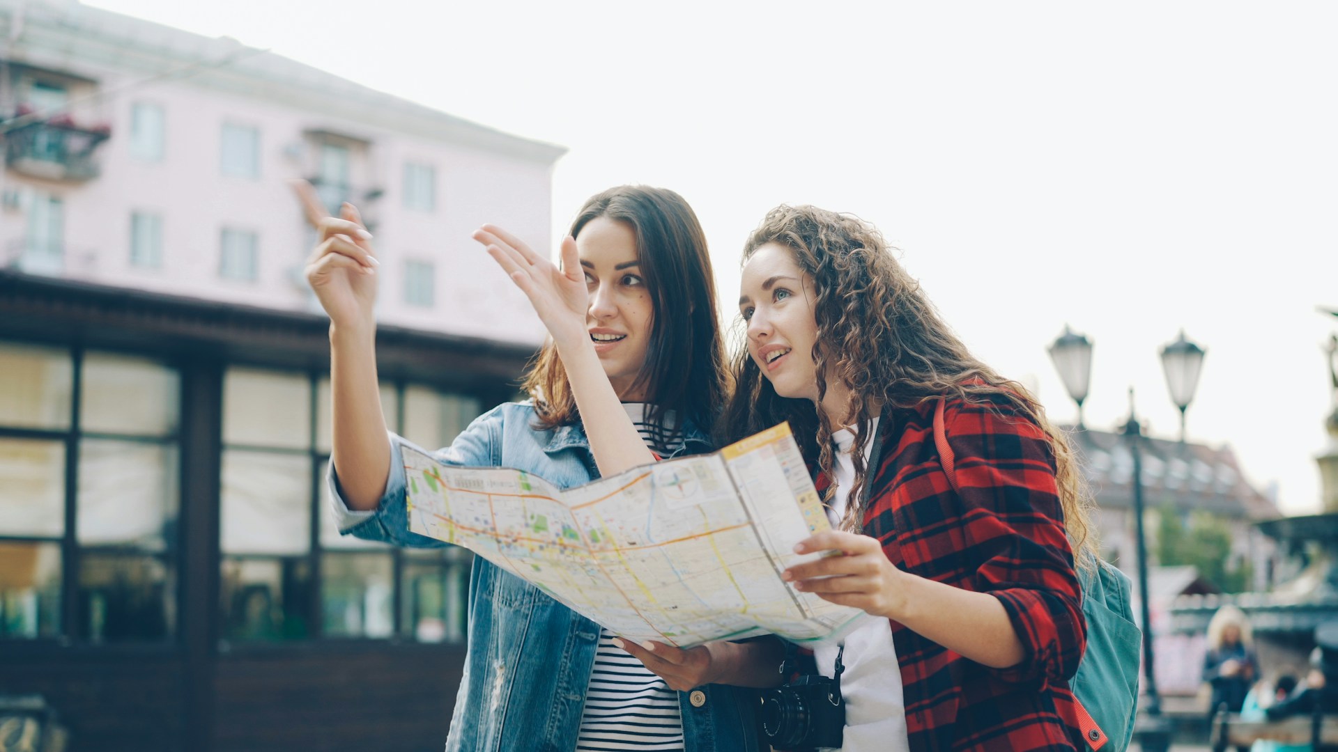 Two women looking at a map together to find directions
